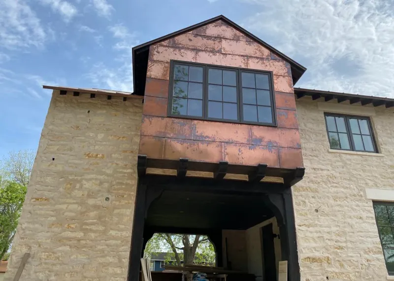 Copper metal panel facade on a stone building for Skylight Installation in Glenarden