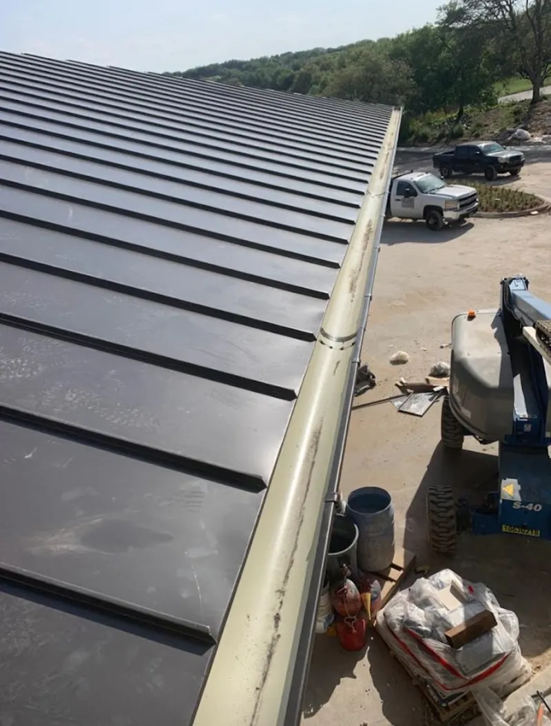 Standing seam panel and gutter detail on a metal roofing jobsite in Glenarden